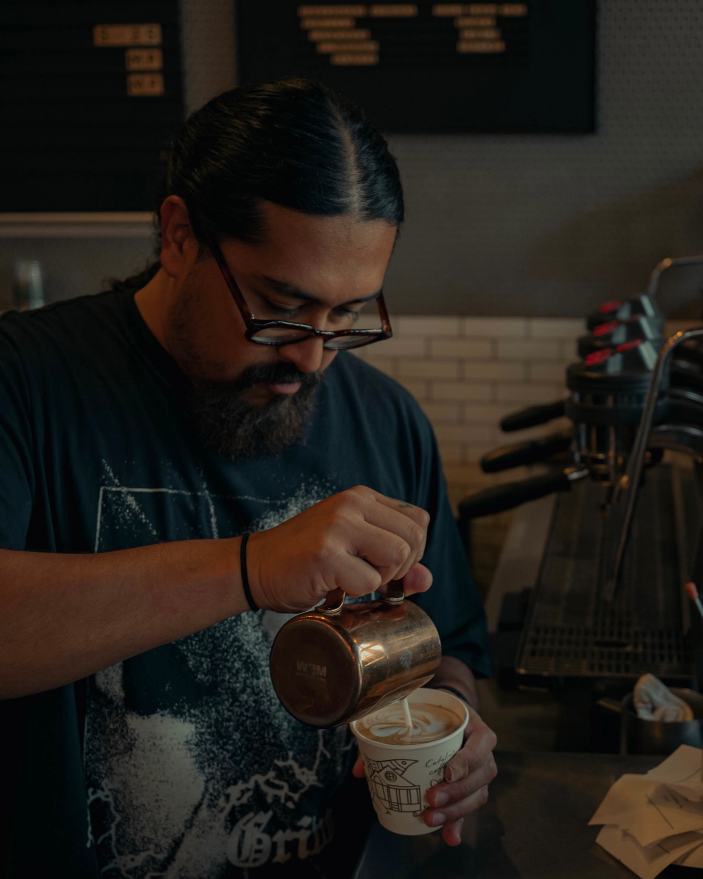 A Catalina barista pouring latte art